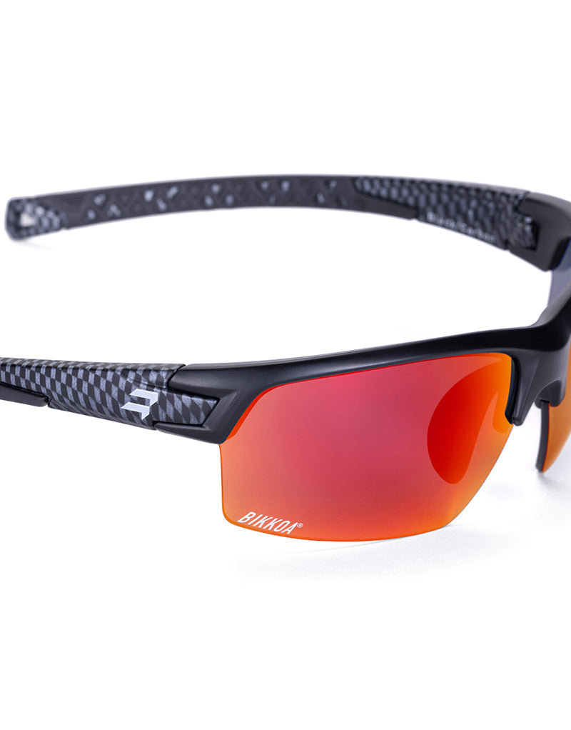 Gafas deportivas BIKKOA GOAT color rojo, detalle de la patilla flexible TR90 y la lente roja REVO en configuración doble - Roja